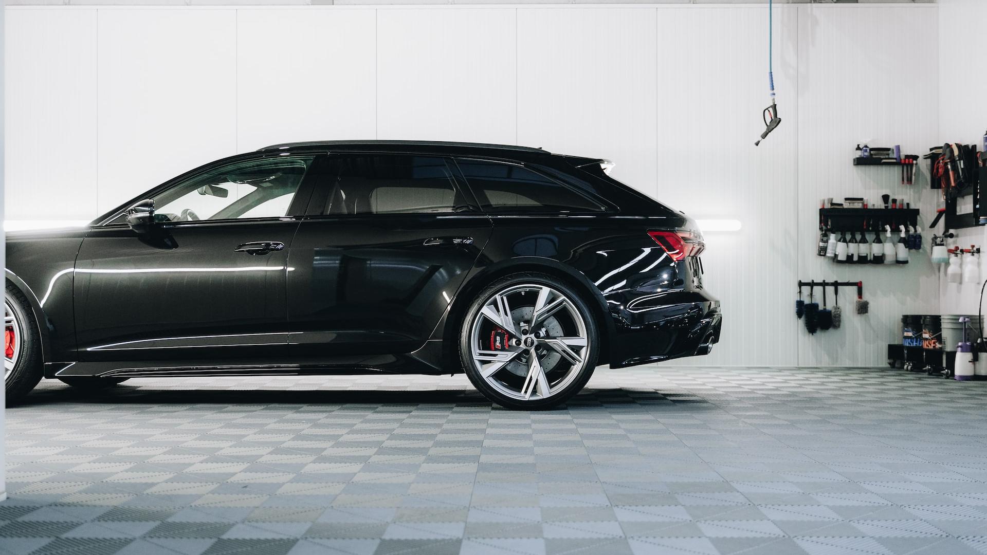 a black car is parked in a garage